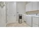 Well-equipped laundry room with modern washer, dryer, sink, and water dispenser at 4916 Tivoli Run, Bradenton, FL 34211