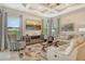 Bright living room with a coffered ceiling, large windows and sliding glass doors, neutral paint and flooring at 4916 Tivoli Run, Bradenton, FL 34211
