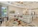 Bright living room view into the kitchen offers an open floorplan, neutral paint, and large windows at 4916 Tivoli Run, Bradenton, FL 34211