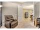 Cozy office space with a recliner and views of the dining room at 4916 Tivoli Run, Bradenton, FL 34211
