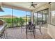 Relax on this screened patio featuring a ceiling fan, stylish outdoor furniture, and a built-in grilling area for entertaining at 4916 Tivoli Run, Bradenton, FL 34211