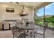 This patio is an outdoor kitchen featuring stainless steel appliances, a built-in grill, and dining area with comfortable seating at 4916 Tivoli Run, Bradenton, FL 34211