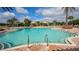 This large pool features clear water, cabanas, lounge seating and palm tree landscaping at 4916 Tivoli Run, Bradenton, FL 34211
