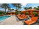 Inviting community pool area with lounge chairs, cabanas, and palm trees at 4916 Tivoli Run, Bradenton, FL 34211