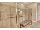 Spacious shower boasts clear glass and an integrated bench, light tile, and safety bars at 4916 Tivoli Run, Bradenton, FL 34211