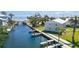 Aerial view featuring waterfront condos with private boat docks and canal access to the sea at 522 Pine Ave # 8B, Anna Maria, FL 34216