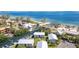 Aerial view showcasing the community waterfront condos near the ocean and a nearby beach at 522 Pine Ave # 8B, Anna Maria, FL 34216