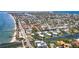 Expansive aerial view of a coastal town with waterfront condos, boat docks, and beach access at 522 Pine Ave # 8B, Anna Maria, FL 34216