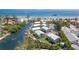 Scenic aerial view of waterfront condo community with private docks, waterways, and lush landscaping at 522 Pine Ave # 8B, Anna Maria, FL 34216