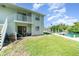 View of building overlooking backyard and the dock on the canal at 522 Pine Ave # 8B, Anna Maria, FL 34216