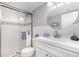 Bathroom with a glass shower, round mirror, modern sink and vanity, and updated fixtures at 522 Pine Ave # 8B, Anna Maria, FL 34216