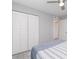 Bright bedroom featuring a closet with louvered doors and a ceiling fan at 522 Pine Ave # 8B, Anna Maria, FL 34216