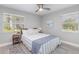 Cozy bedroom featuring light-colored walls, ceiling fan, bedside tables, and plenty of natural light at 522 Pine Ave # 8B, Anna Maria, FL 34216