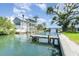 Beautiful waterfront home boasting multiple balconies and a private boat dock on a sunny day at 522 Pine Ave # 8B, Anna Maria, FL 34216