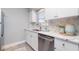Modern kitchen featuring white cabinets, marble countertops, stainless steel appliances, and a window with a view at 522 Pine Ave # 8B, Anna Maria, FL 34216