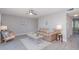 Comfortable living room with neutral decor and a ceiling fan, complemented by wood-look tile flooring at 522 Pine Ave # 8B, Anna Maria, FL 34216