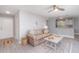 Cozy living room featuring neutral walls, a ceiling fan, and a view into the kitchen and dining area at 522 Pine Ave # 8B, Anna Maria, FL 34216