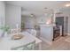 Open-concept living space with combined kitchen, dining and living areas, wood-look tile floors, and stainless steel appliances at 522 Pine Ave # 8B, Anna Maria, FL 34216