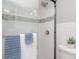 Close up of modern shower with glass door, updated fixtures and decorative tile at 522 Pine Ave # 8B, Anna Maria, FL 34216