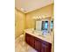 Well-lit bathroom featuring a double sink vanity with wood cabinets at 5620 Whitehead St, Bradenton, FL 34203