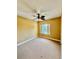 Carpeted bedroom featuring a ceiling fan and window with blinds at 5620 Whitehead St, Bradenton, FL 34203