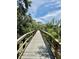 Scenic boardwalk surrounded by lush greenery with a view of the water at 5620 Whitehead St, Bradenton, FL 34203