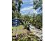 A wooden walking bridge surrounded by lush greenery with a sign indicating local attractions at 5620 Whitehead St, Bradenton, FL 34203