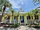 Charming clubhouse with palm trees and signage indicating access to the community pool, spa, and fitness center at 5620 Whitehead St, Bradenton, FL 34203