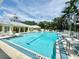 Expansive community pool featuring lounge chairs, landscaping, and a clear view of the clubhouse building at 5620 Whitehead St, Bradenton, FL 34203