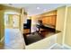 Well-lit kitchen features granite counters, dark appliances, and a view towards entryway at 5620 Whitehead St, Bradenton, FL 34203