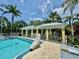 Relaxing pool area with covered seating, perfect for enjoying the outdoors with a pristine pool and lush landscaping at 5620 Whitehead St, Bradenton, FL 34203