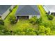 Aerial view of backyard with screened patio surrounded by lush greenery for privacy at 5927 Maidenstone Way, Palmetto, FL 34221
