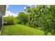 Lush backyard featuring vibrant green grass and mature trees for a private outdoor space at 5927 Maidenstone Way, Palmetto, FL 34221