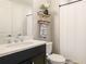Modern bathroom features sleek vanity, open shelving and a shower-tub combination, providing a spa-like experience at 5927 Maidenstone Way, Palmetto, FL 34221