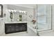 Bright bathroom with double vanity, soaking tub, and frameless glass shower enclosure at 5927 Maidenstone Way, Palmetto, FL 34221