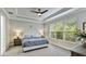 Main bedroom features a decorative ceiling, neutral walls, and a large window with a view of greenery at 5927 Maidenstone Way, Palmetto, FL 34221