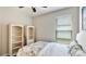 Bright bedroom with a window view and two white shelving units create a perfect blend of comfort and functionality at 5927 Maidenstone Way, Palmetto, FL 34221