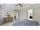 Relaxing bedroom features a decorative tray ceiling, neutral walls, and ensuite bath access at 5927 Maidenstone Way, Palmetto, FL 34221