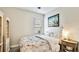 Comfortable bedroom with a full-sized bed, soft lighting, and a charming bedside table, offering a relaxing space at 5927 Maidenstone Way, Palmetto, FL 34221