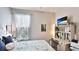 Cozy bedroom featuring natural light, a comfortable bed, and a convenient built-in desk and shelving unit at 5927 Maidenstone Way, Palmetto, FL 34221