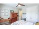 Bright bedroom boasts a ceiling fan, wood desk, and matching dresser for ample storage solutions at 5927 Maidenstone Way, Palmetto, FL 34221