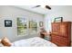Light filled bedroom featuring two windows, warm wood accents, and ample natural light, creating a cozy retreat at 5927 Maidenstone Way, Palmetto, FL 34221