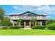Stunning clubhouse with detailed stone columns, lush landscaping, and a manicured lawn at 5927 Maidenstone Way, Palmetto, FL 34221