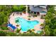 Aerial view showcasing a community pool, lush landscaping, seating areas, and a nearby building at 5927 Maidenstone Way, Palmetto, FL 34221