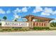 Community entrance featuring brick pillars, landscaping, and Artisan Lakes signage for a welcoming feel at 5927 Maidenstone Way, Palmetto, FL 34221
