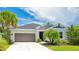 Lovely single-story home showcasing a well-manicured lawn, landscaping, and attached two-car garage at 5927 Maidenstone Way, Palmetto, FL 34221