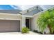 Stylish front exterior featuring a welcoming entrance, neutral paint, and a two-car garage at 5927 Maidenstone Way, Palmetto, FL 34221
