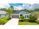Charming single-story home featuring a two-car garage, well-manicured lawn, and mature landscaping at 5927 Maidenstone Way, Palmetto, FL 34221
