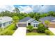 Beautiful single-story home with a well-maintained lawn, a two-car garage, and lush trees at 5927 Maidenstone Way, Palmetto, FL 34221