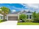 Charming single-story home featuring a two-car garage, well-manicured lawn, and mature landscaping at 5927 Maidenstone Way, Palmetto, FL 34221